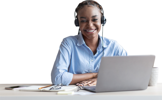 Person with a headset and laptop smiling at the camera